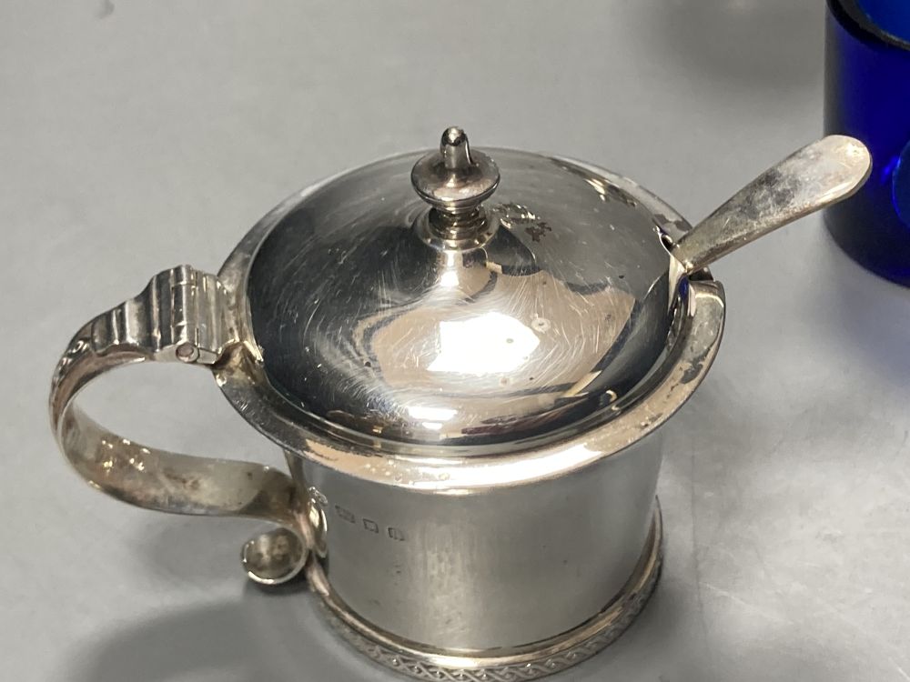 A George V silver three piece condiment set, London, 1923, a pair of silver pepperettes & four other silver condiments.